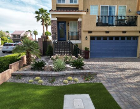 A house with a driveway and lawn in front of it.