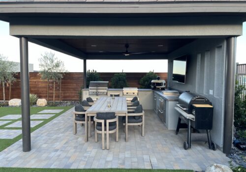 A patio with an outdoor grill and table