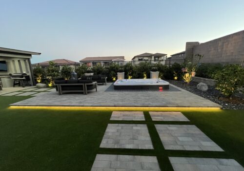 A view of an outdoor area with a pool and grass.