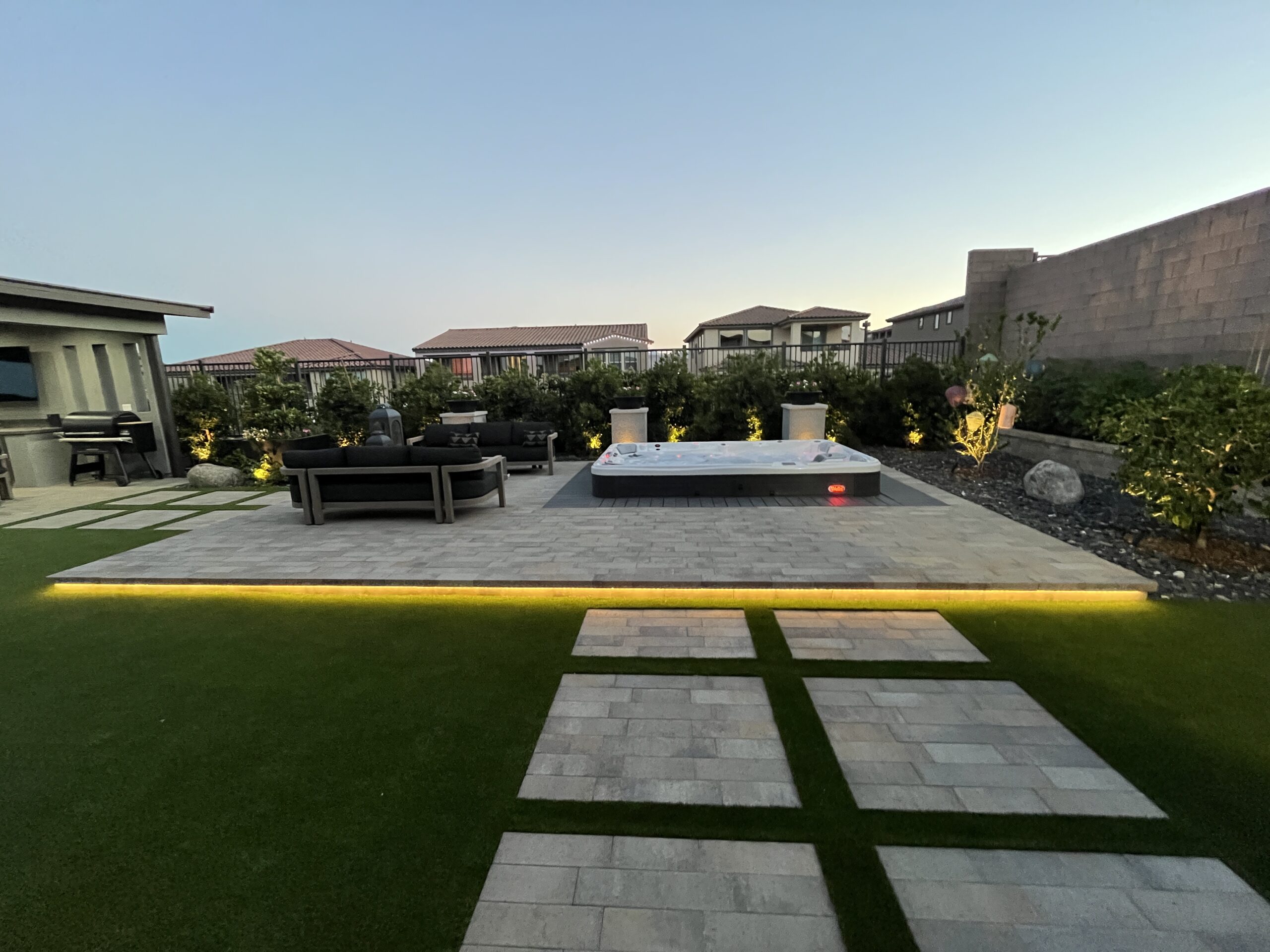 A view of an outdoor area with a pool and grass. A view of an outdoor area with a pool and grass.