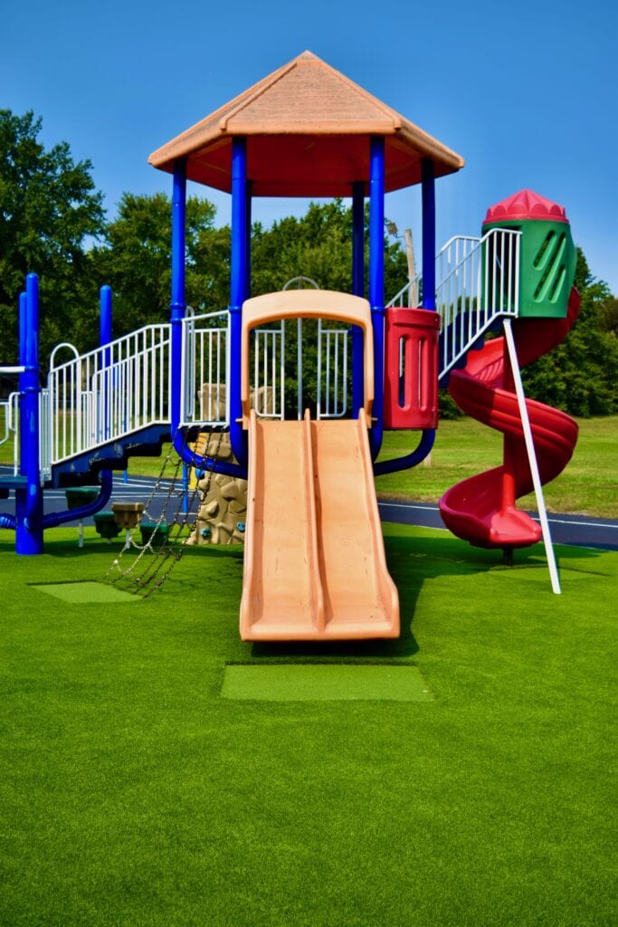 A playground with slides and swings for children. A playground with slides and swings for children.
