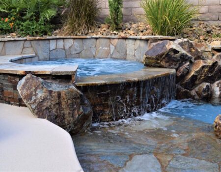 A hot tub with rocks and water in it